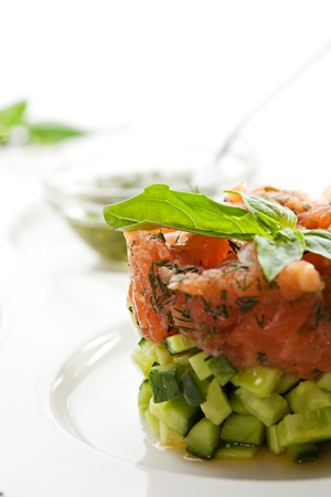 Salmon with Cucumber Tartare with Egg Yolk and Pesto Sauceの写真素材