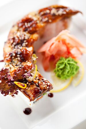 Roll made of Fresh Salmon, Cream Cheese and Cucumber inside. Topped with Smoked Eel (unagi)の写真素材