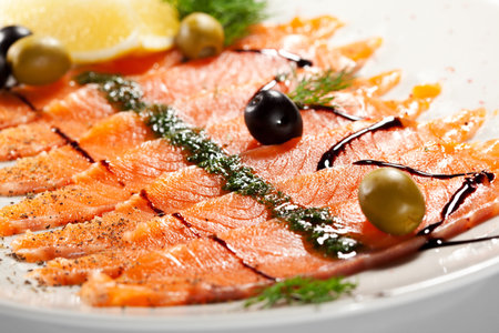 Appetizer - Salmon Carpaccio with Balsamic Sauce, Olives and Lemon Sliceの写真素材