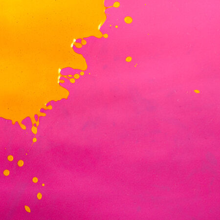 Yellow Paint Splash over Magenta Backgroundの写真素材