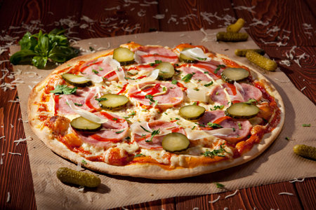 Pizza with Ham, Pickled Cucumber, Tomatoes and Mozzarella Cheeseの写真素材