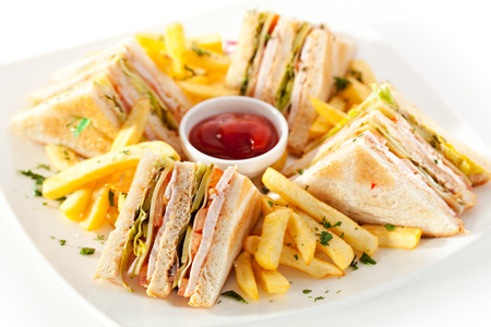 Club Sandwich with Cheese, PIckled Cucmber, Tomato and Smoked Meat. Garnished with French Friesの写真素材