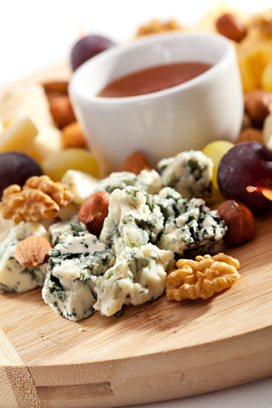 Cheese Plate with Grapes, Nuts and Honeyの写真素材