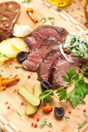 Roast Beef with Pickled Cucumber and Onions, Boiled Potato, Mushrooms and Toastの写真素材