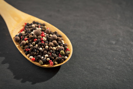 Pepper Wooden Spoon on Black Backgroundの写真素材