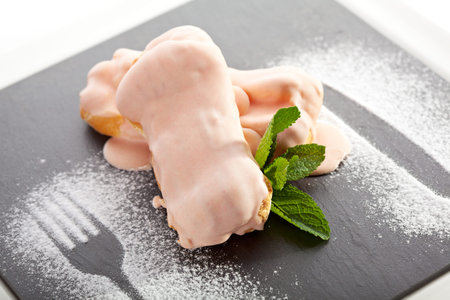 Cream Dessert Eclair on Black Plate