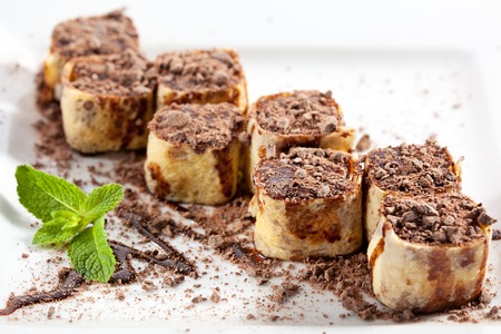 Dessert Maki Sushi - Chocolate Roll with Various Fruit and Cream Cheese inside. Pancake outside. Served with Chocolate Crumbの写真素材