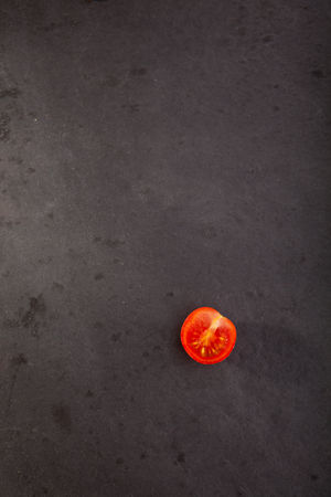 Cherry Tomato on Black Slate Backgroundの写真素材
