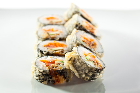 Tempura Maki Sushi - Deep Fried Roll made of Fresh Salmon, Avocado Smoked Eel and Tobiko Caviar insideの写真素材