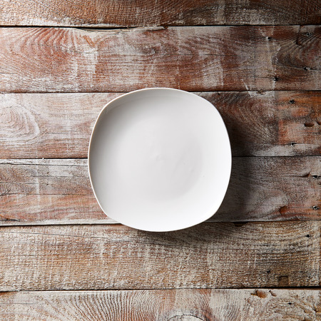 Empty White Plate on Wooden Tableの写真素材