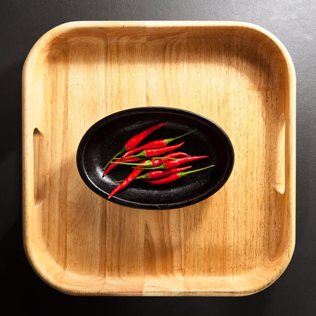 Red Chili Pepper on Wooden Trayの写真素材
