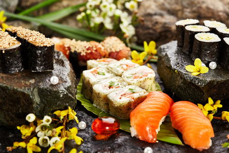 Japanese Sushi Set - Various Maki Sushi Roll and Nigiri Sushi. Japanese Cuisine and Natural Flower Conceptの写真素材