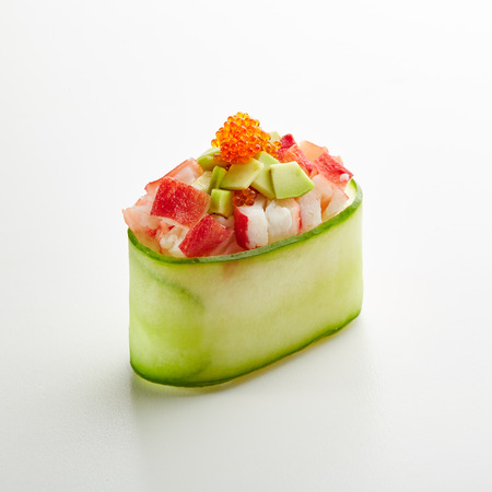 Japanese Sushi - Crab Meat and Avocado Gunkan Sushi with Tobiko on White Background. Cucumber Slice outsideの写真素材