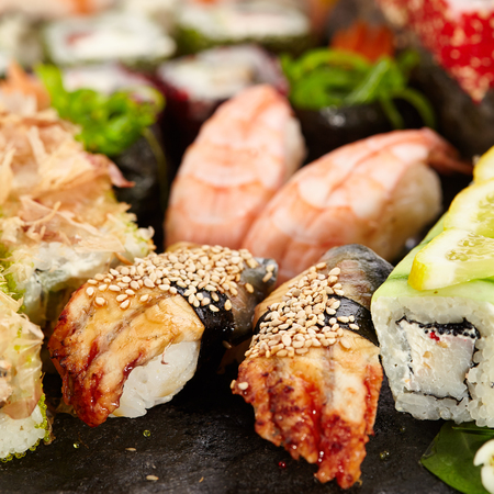 Japanese Sushi Set - Various Maki Sushi Roll and Nigiri Sushi. Japanese Cuisine and Natural Flower Conceptの写真素材