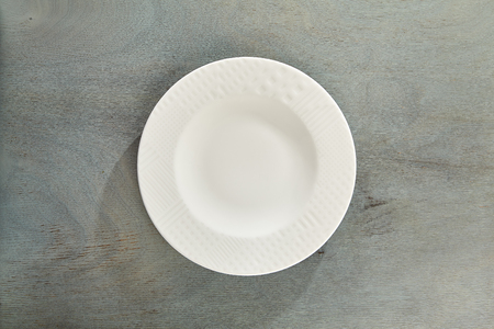 Empty Plate on Gray Wood Table Backgroundの写真素材