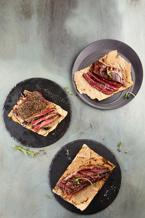 Restaurant Grilled Food - Delicious Grilled Various Steak. Gourmet Restaurant Steak Menu. Steak Served on Black Dishの写真素材