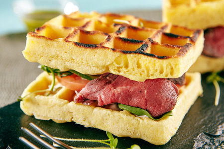 Restaurant Hot Starter Food - Rare Beef Waffle Sandwich. Gourmet Restaurant Appetizers Menu. Rare Beef Waffle Sandwich Served with Greens and Vegetablesの写真素材