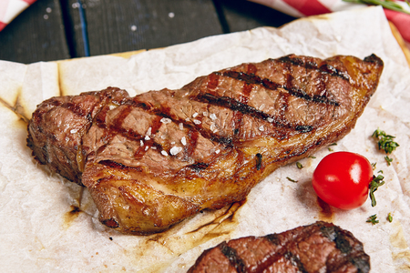 Gourmet Grill Restaurant Steak Menu - New York Beef Steak on Wooden Background. Black Angus Prime Beef Steak. Beef Steak Dinner. Top VIewの写真素材