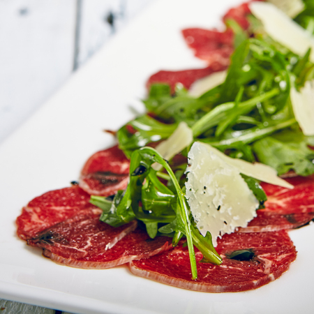 Meat Carpaccio with Rocket Salad and Parmesan Cheeseの写真素材