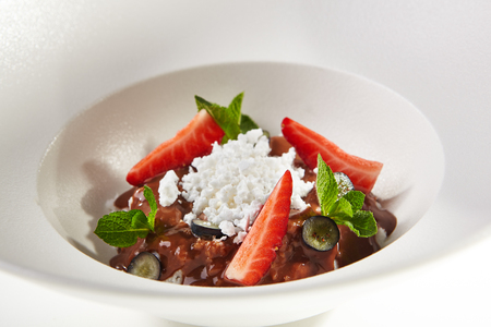 Gourmet Dessert with Ice Cream, Berries, Chocolate and Tropic Fruitsの写真素材