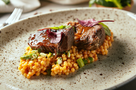 Close-up portrait of exquisite delicacy food. Bird beef with green asparagus served on nice beige plate. Nutrition fresh organic restaurant meal conceptの写真素材
