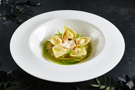 Beautiful Serving White Restaurant Plate of Tortellini with Shrimps and Young Zucchini Ragout.の写真素材