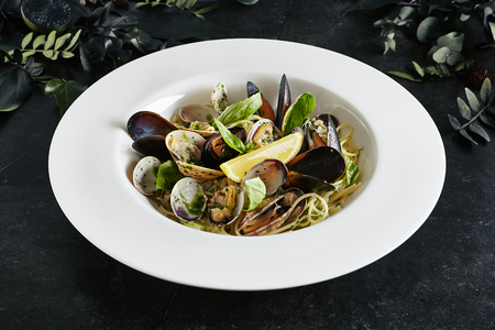 Exquisite Serving White Restaurant Plate of Spaghetti  with Sea Shells in Wine Sauceの写真素材