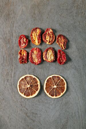 Food Art Concept with Abstract Brain Monster made of Dried Orange Slices and Tomatoes Top Vew. Creative Autumn Layout with Eyed Human Faceの写真素材