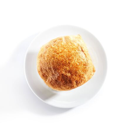 Top view of julienne or potage soup with chicken and mushrooms topped with melted cheese or puff pastry on white restaurant plate isolated.の写真素材