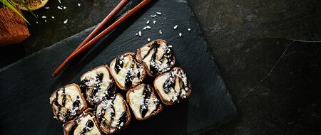 Macro Photo of Chocolate Maki Sushi Pancake Rolls Stuffed with Fruits and Cheese Close Up.の写真素材