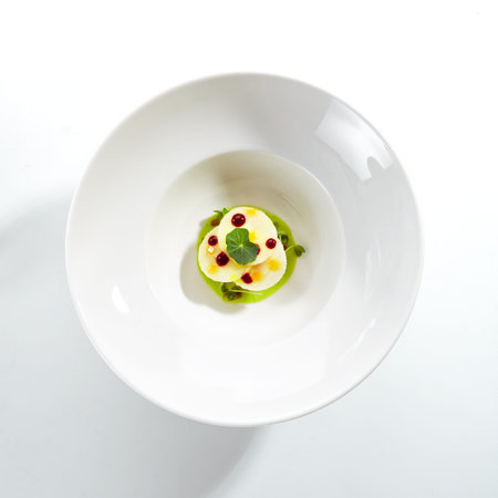 Exquisite serving scallop in pesto sauce with mozzarella on white restaurant plate isolated. High...