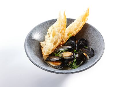 Mussels with baguette slice. Served fresh oysters with bread close up.の写真素材
