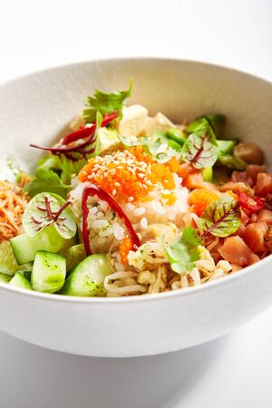 Poke with salmon, cut avocado and tofu closeup view. Traditional hawaiian dish served with cheese. Delicious salad with rice, edamame and soybean. Native cuisine, exotic food compositionの写真素材