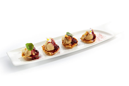 Turkey liver pate with berry sauce side view. Forcemeat paste snacks served with greenery and...