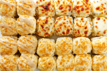 Baked rolls on white background top view. Delicious sashimi, tasty hot sushi close up. Asian cuisine rice and seafood meal, traditional japanese eating, restaurant food presentationの写真素材