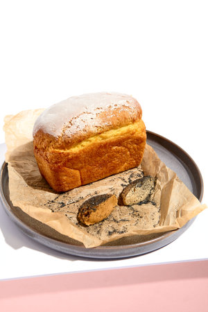 CornBread on white table. White table and pink wall in sunlight with hard shadow. Summer day food conceptの写真素材