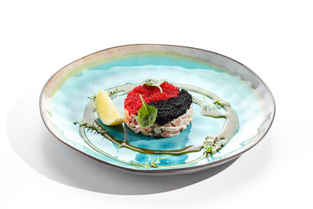 Yin yang salad topped with red and black tobiko. Japanese seafood salad with crab meat, avocado....