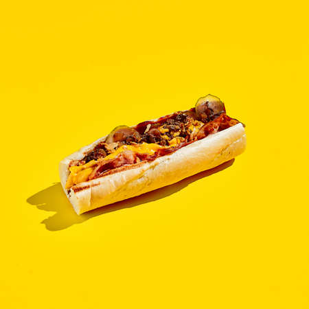 Beef cheesesteak in minimal style. American fast food in yellow background with shadow. Philly steak sandwich trendy concept. Junk food in color backgroundの写真素材