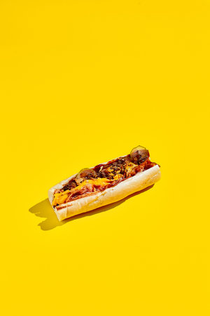 Beef cheesesteak in minimal style. American fast food in yellow background with shadow. Philly steak sandwich trendy concept. Junk food in color backgroundの写真素材