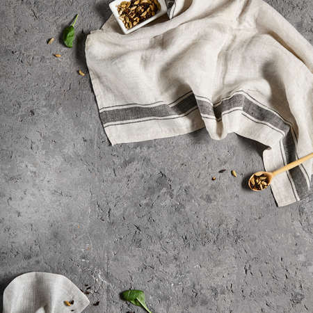 Empty gray stone background with textile and ingredients. Food background in rustic style. Cement table with kitchen towel and spices. Aesthetic minimal backgroundの写真素材