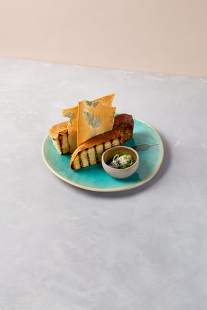 Bread dish with organic butter on blue ceramic plate. Artisan bread from chef. contemporary baking....