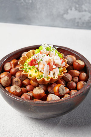 Appetizer with crab meat, edamame beans and creamy sauce. Fine dining: Tartlet with crab. Seafood...