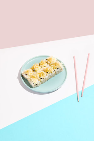 Cheese maki roll on blue ceramic plate. Sushi roll in Caesar style on colored backdrop. Sushi menu...