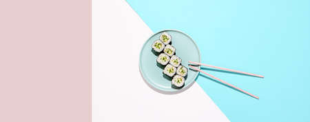 Classic japanese sushi with fresh cucumber - kappa maki. Kappa hosomaki in minimal style. Simple maki sushi with cucumber. Vegan sushi rollの写真素材