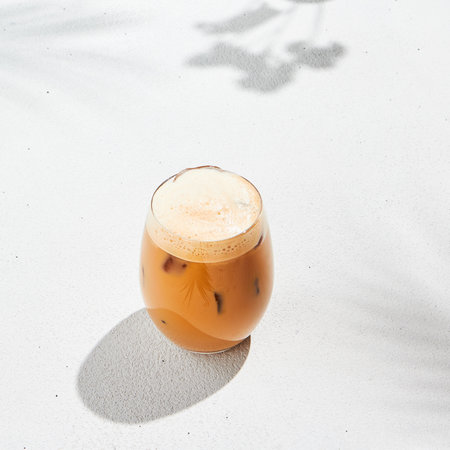 Assorted iced coffee on white concrete background with palm shadows. Minimal composition with cold summer drinks: espresso tonic, ice moccachino and latte. Summer composition for coffee menuの写真素材