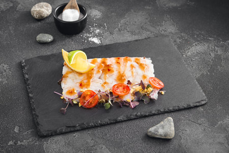A delicate arrangement of thinly sliced shrimp carpaccio, adorned with sweet chili sauce, fresh...
