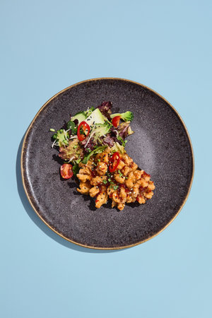 Chinese-style sweet and sour carp with vegetables; an artistic food presentation set against a surreal seasonal backdrop.の写真素材
