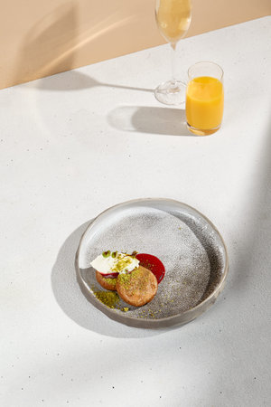Stylish Breakfast Arrangement with Syrniki, Sour Cream, Fruit Sauce, Orange Juice, and Sparkling...