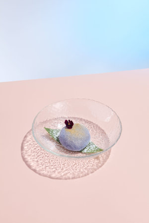 Traditional Mochi Dessert with a Minimalist Pink and Blue Presentation for a Contemporary Menu.の写真素材