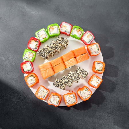 Assorted sushi rolls with salmon, tobiko caviar, and sesame seeds, a feast for sushi enthusiasts.の写真素材